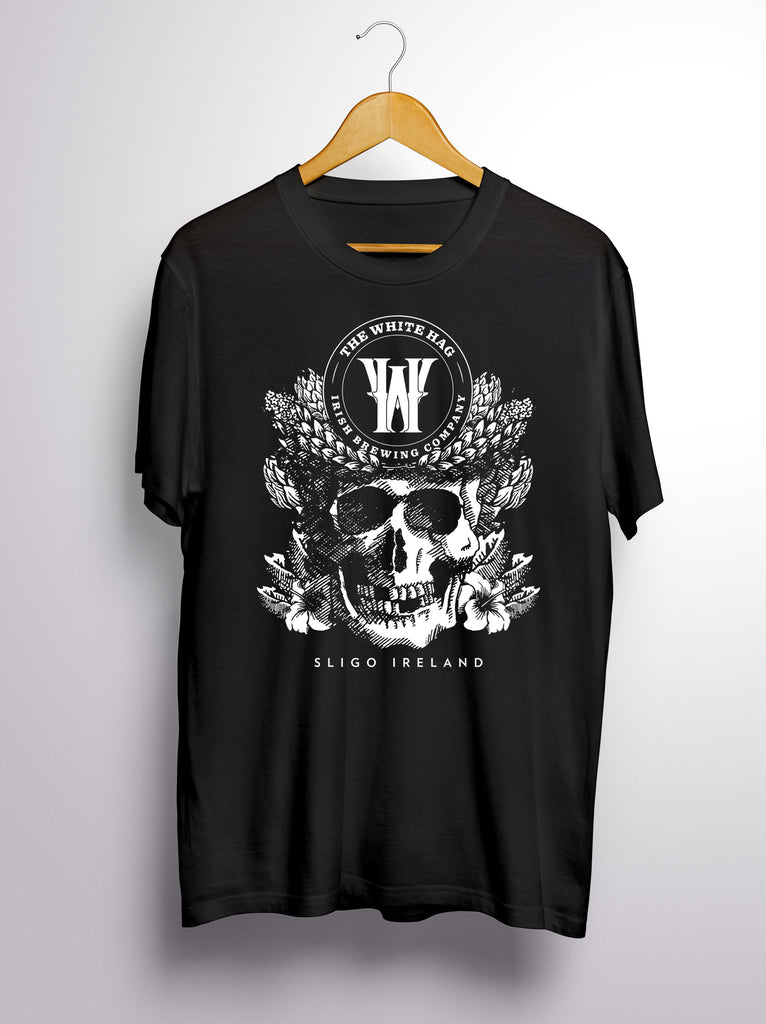 Black t-shirt with skull and floral design on a hanger against a white background